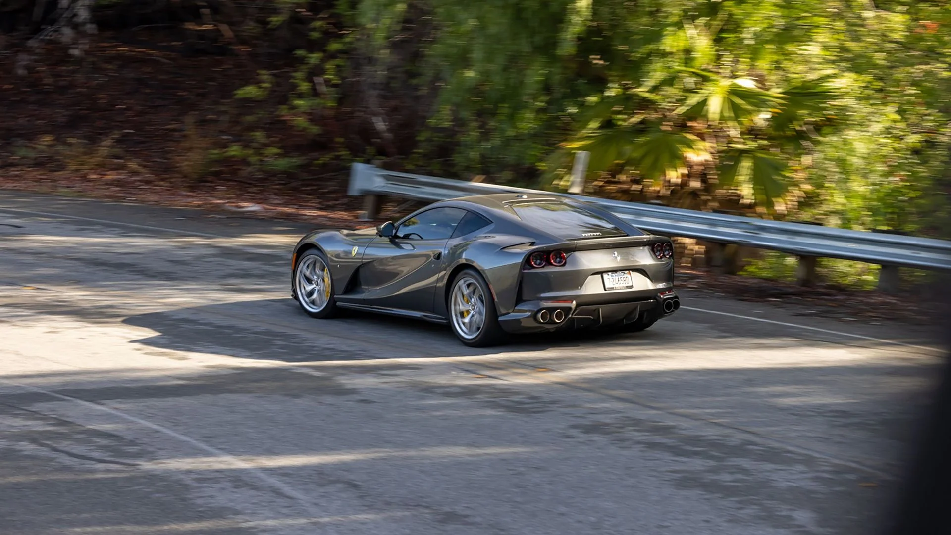 Ferrari driving through a winding California road