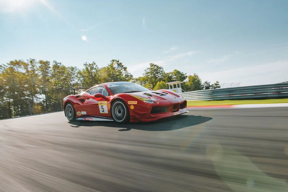Ferrari performance car driving on a racetrack
