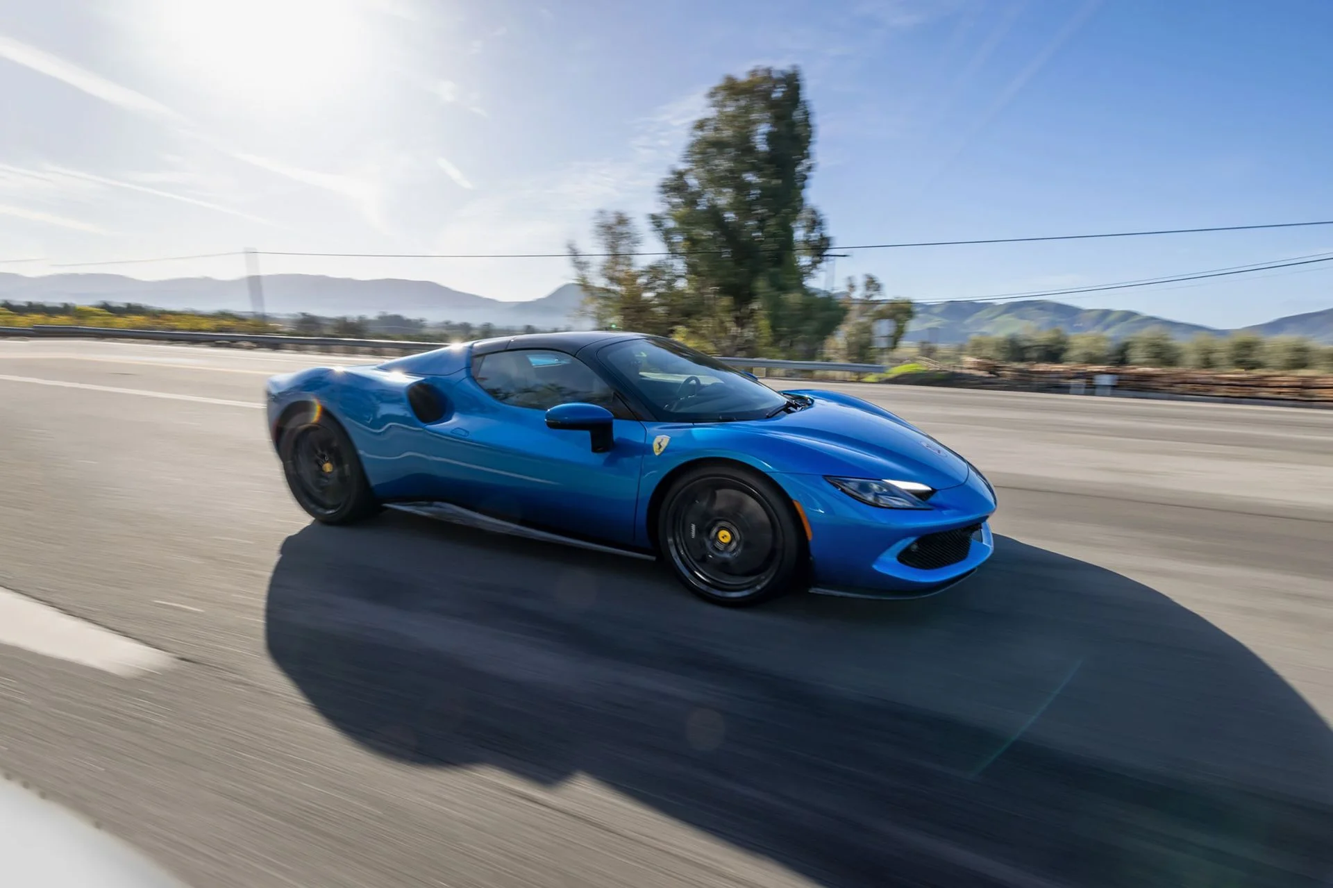 Ferrari 296 GTS driving on an open road
